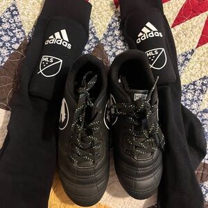 Adidas Black soccer cleats and shin guards